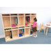 Child interacting with a wooden storage unit in a classroom setting