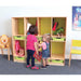 Two young children standing in front of a light wood toy organizer cubby shelf with green drawer bins in a children's room.